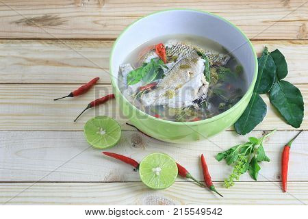 Gerres oyena or Common silver-biddy fish of hot and sour soup on wooden floor and have copy space to design in your work.