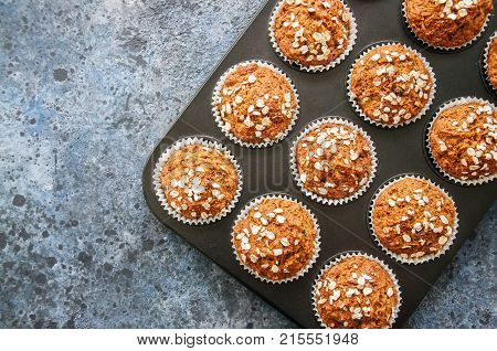 Carrot Cake Muffins With Nuts, Raisins And Oats On A Blue Stone Background. Top View With Copy Space