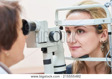 ophthalmology. female doctor checks eyesight at woman