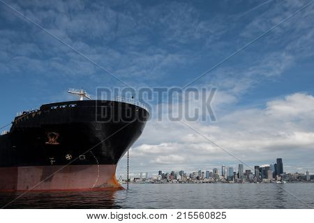 Bulk Carrier at anchor in Seattle's Elliott Bay on Sunny windless day with city in background