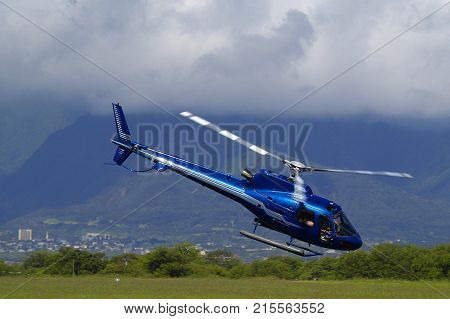 Tour Helicopter taking off from Kahului Airport Maui HI