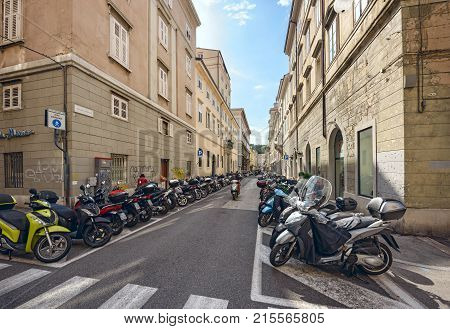 TRIESTE/ ITALY - OCTOBER 9, 2017.  Parking of motorcycles on both sides of the street in the city centre. Trieste, region Friuli-Venezia Giulia, Italy.