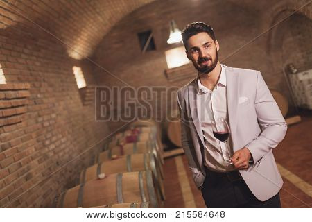 Oenologist tasting wines in wine grower cellar