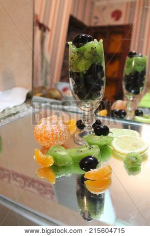 beautiful fresh sweet juicy fruits in wine crystal glass for mix cocktail
