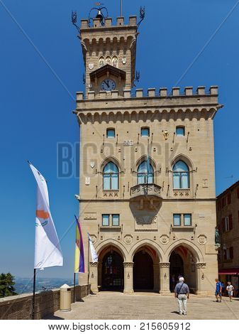 SAN MARINO, SAN MARINO - JUNE 13, 2017: People on the Piazza Liberta in front of Palazzo Pubblico, the Public Palace. It was built between 1884 and 1894 by design of Francesco Azzurri