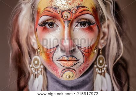 Girl portrait with painted face in halloween style shooted closeup