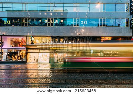 Helsinki, Finland - December 8, 2016: Tram Departs From A Stop On Aleksanterinkatu Street. Night View Of Aleksanterinkatu Street In Kluuvi District In Evening Or Night Illumination.