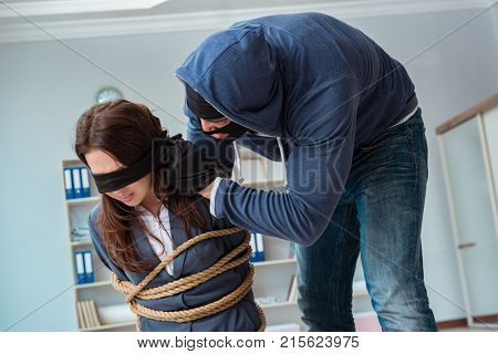 Criminal taking businesswoman as hostage in office
