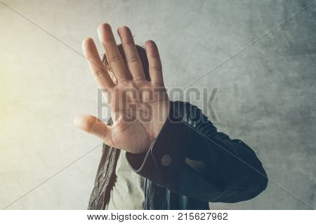Celebrity male hiding face with hands from paparazzi photographers no photos gesture