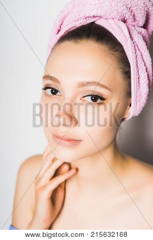 girl after shower with pink towel on her head cute looks at camera, isolated