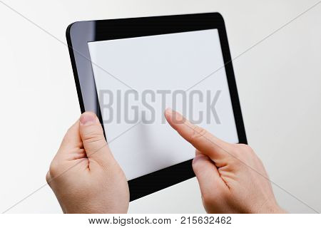 Man hoding black tablet frame in hand isolated on white closeup. Can insert an image image your text for the concept or project development of mobile applications, their advertising for mobile devices