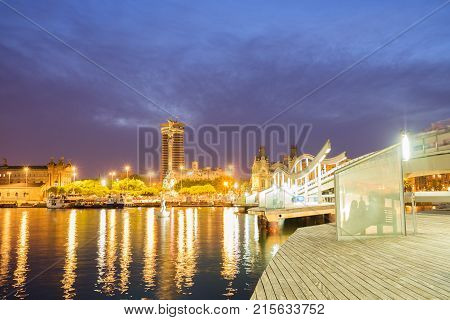 Rambla Maritim, central street of Barcelona illuminted at night, Spain