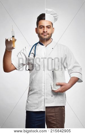Handsome young man dressed as a doctor with stethoscope on one side and as a professional cook on the other cooking kitchen cusine medicine healthcare healthy eating dieting concept.