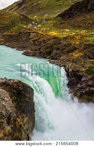 The rumbling waterfall Salto Grande. Travel to Patagonia, southern Province of Chile. Concept of extreme and ecological tourism