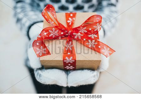 Women presents a Christmas red box present