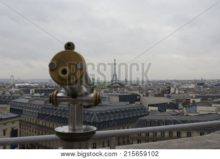 Eiffel Tower and telescope viewer in Paris, France taken from Gallery Lafayette
