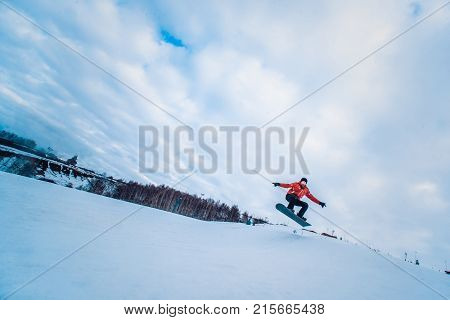 Snowboarder In A Black Helmet Riding On A Snowy Track.
