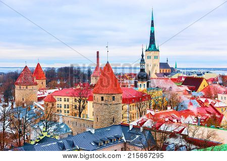 Cityscape with St Olaf Church and defensive towers at the Old town of Tallinn Estonia in winter. View from Toompea hill