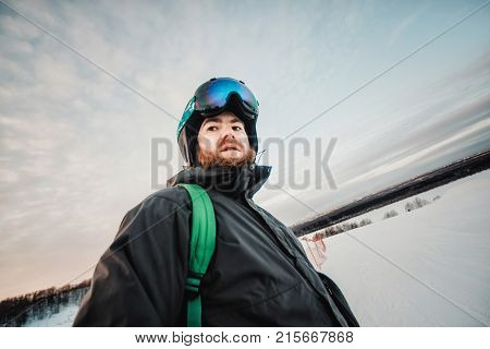 Snowboarder In A Black Helmet Riding On A Snowy Track.