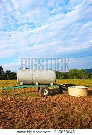Water trough for drinking for cow cattle at the field Franche Comte France.