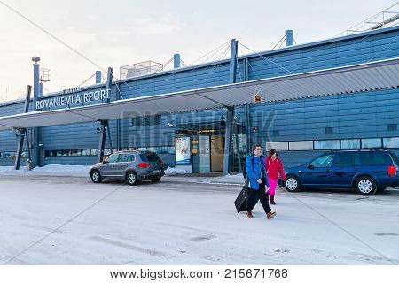 March 5 2017 - Rovaniemi Finland: Young couple with luggage bags leaving Rovaniemi airport in winter
