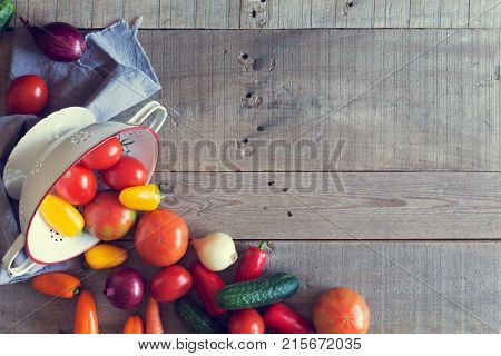 Fresh vegetables on a wooden background. Top view. Toned photo