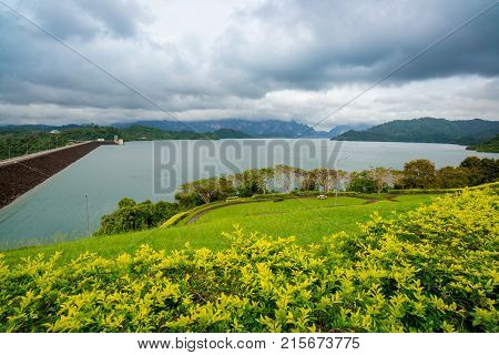 Dam behind a Green Garden with dark cloudy at the Southern of Thailand (Surat Thani)