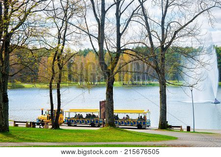 Excursion train with tourists water fountain on Druskonis Lake and the nature in Druskininkai Lithuania