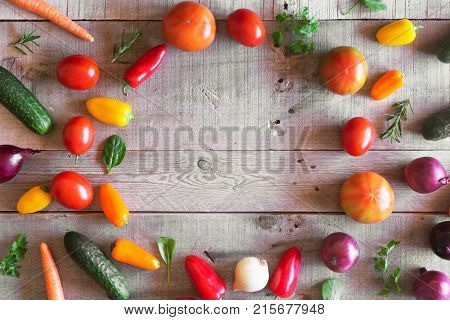 Fresh vegetables on a wooden background. Top view with copy space