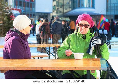 Senior Women Eating Street Food At Lordi Square Winter Rovaniemi