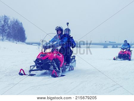 People Riding Snowmobiles At Winter Rovaniemi