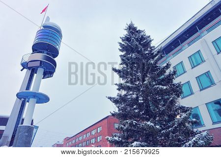 Clock and Christmas tree on Lordi Square in winter Rovaniemi Lapland Finland.