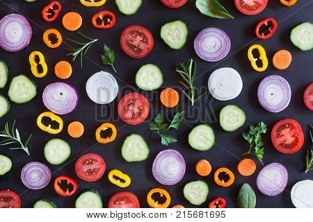 Fresh vegetables on a black chalkboard. Top view