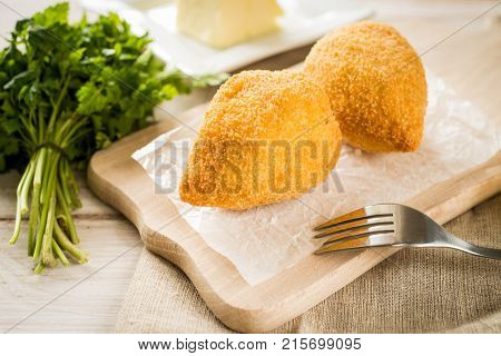 Chicken Kiev cutlets with parsley leaves and butter.