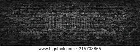 panorama of black brick wall for site caps as background. brick wall