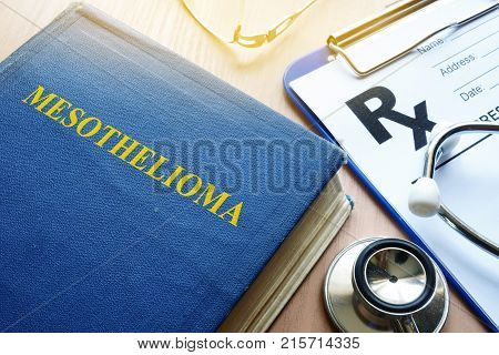 Book about Mesothelioma and stethoscope on a table.