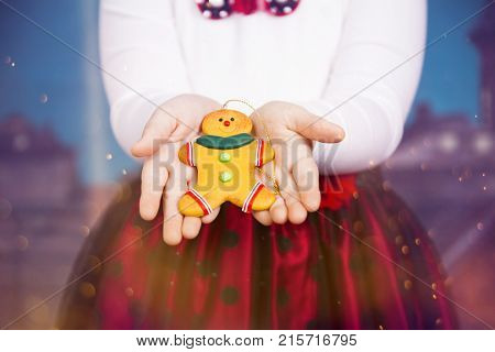 Little girl with beautiful Christmas dress holding gingerbred cookie - Christmas concept