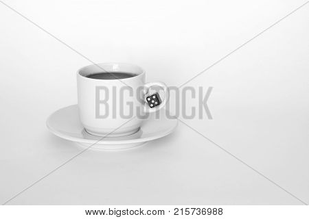 A Cup Of Coffee With Dice On White Background