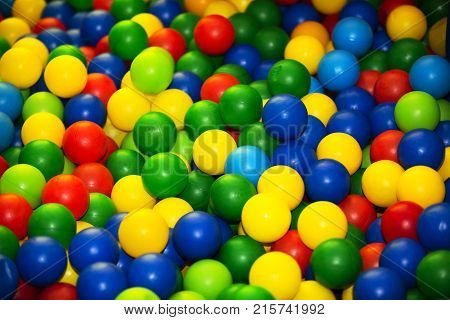 Plastic multi-colored balls. Many colored plastic multi-colored balls