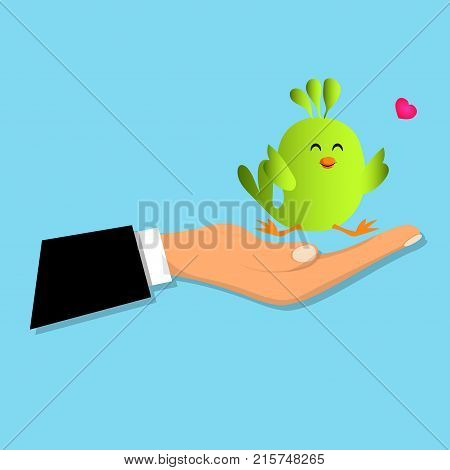 Cute green bird sitting on a male hand. Cute bird toy or animal presenting