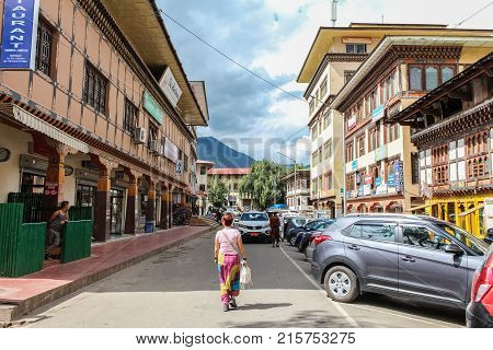 Thimphu Bhutan - September 11 2016: Caucasian tourist walking in the street of Thimphu capital city of Bhutan Asia.