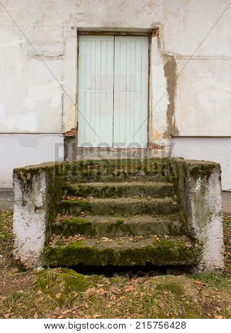 old painted door and porch covered with moss
