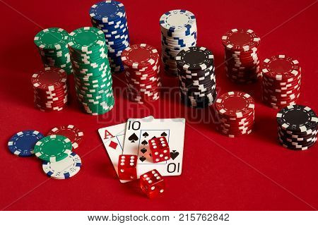 Poker cards and gambling chips on red background. Top view. Copy space. Still life. Flat lay. Cards - Ace and Ten