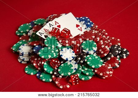 Poker cards and gambling chips on red background. Top view. Copy space. Still life. Flat lay. Cards - four aces. 4 of a kind