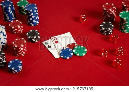 Poker cards and gambling chips on red background. Top view. Copy space. Still life. Flat lay. Cards - Ace and Ten