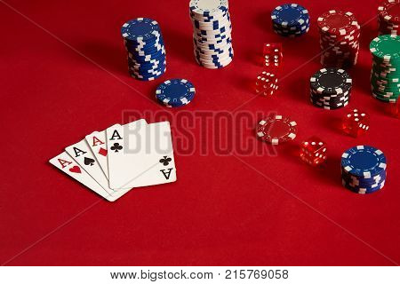 Poker cards and gambling chips on red background. Top view. Copy space. Still life. Flat lay. Cards - four aces. 4 of a kind