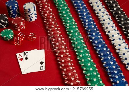 Poker cards and gambling chips on red background. Top view. Copy space. Still life. Flat lay. Cards - Ace and Ten