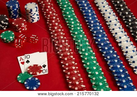 Poker cards and gambling chips on red background. Top view. Copy space. Still life. Flat lay. Cards - Ace and Ten