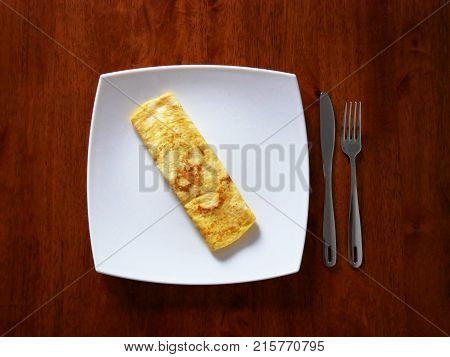Classic omelet on the white plate. Fresh breakfast.