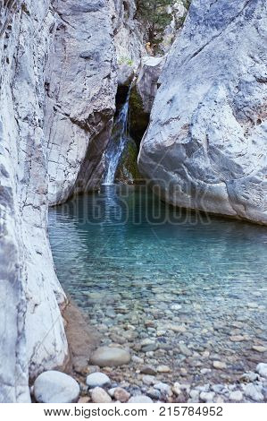 Cascade on the mountain river in the canyon in summer.